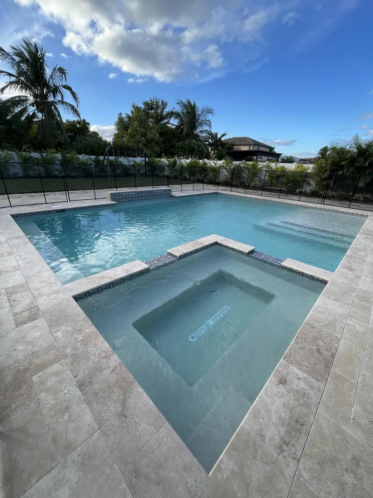 Modern L-shaped geometric inground pool and integrated raised spa in Miami-Dade by Bluewater Design Studio